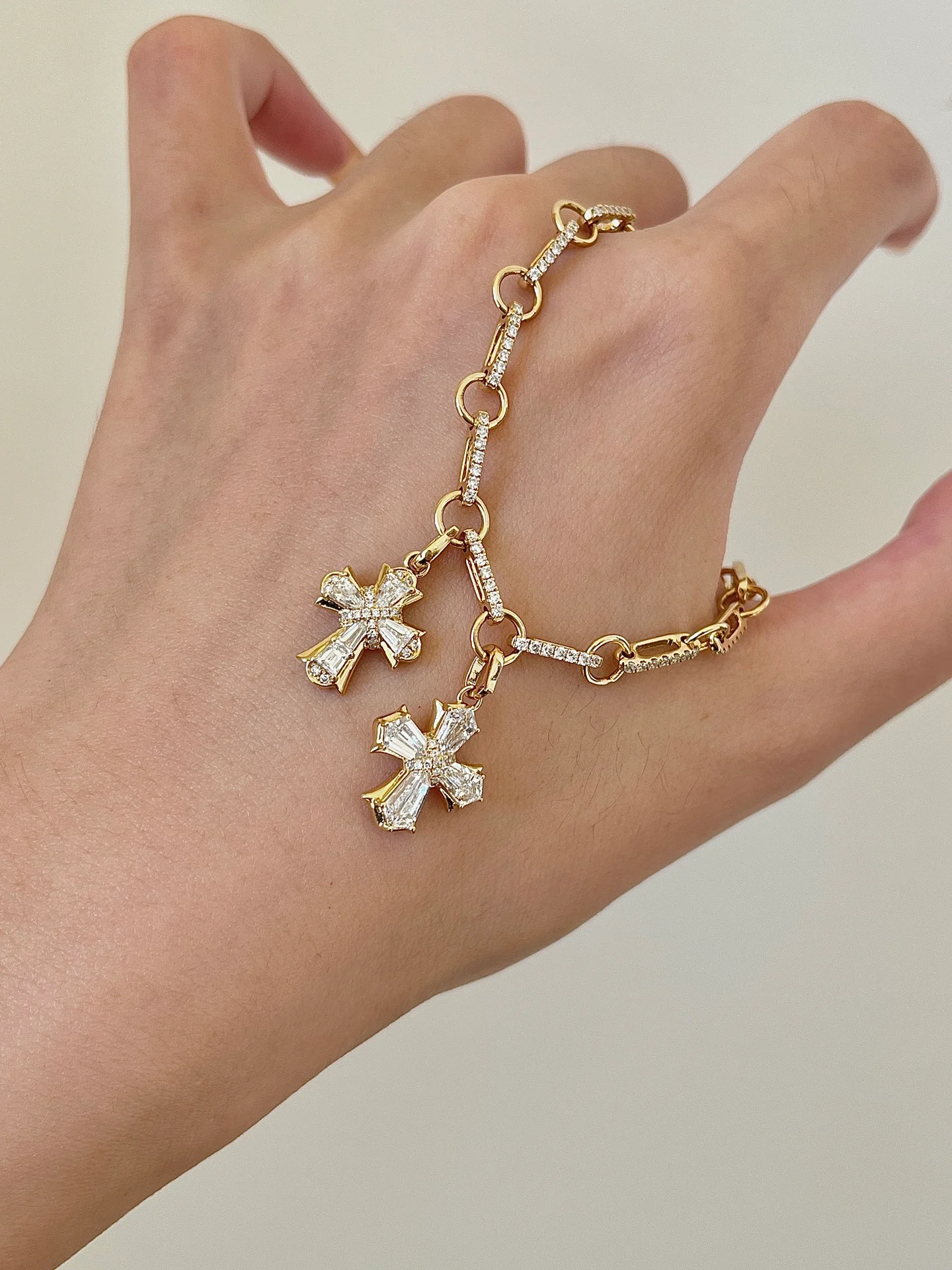 Cross-charm bracelet 001 · Hand view (supplied photograph)