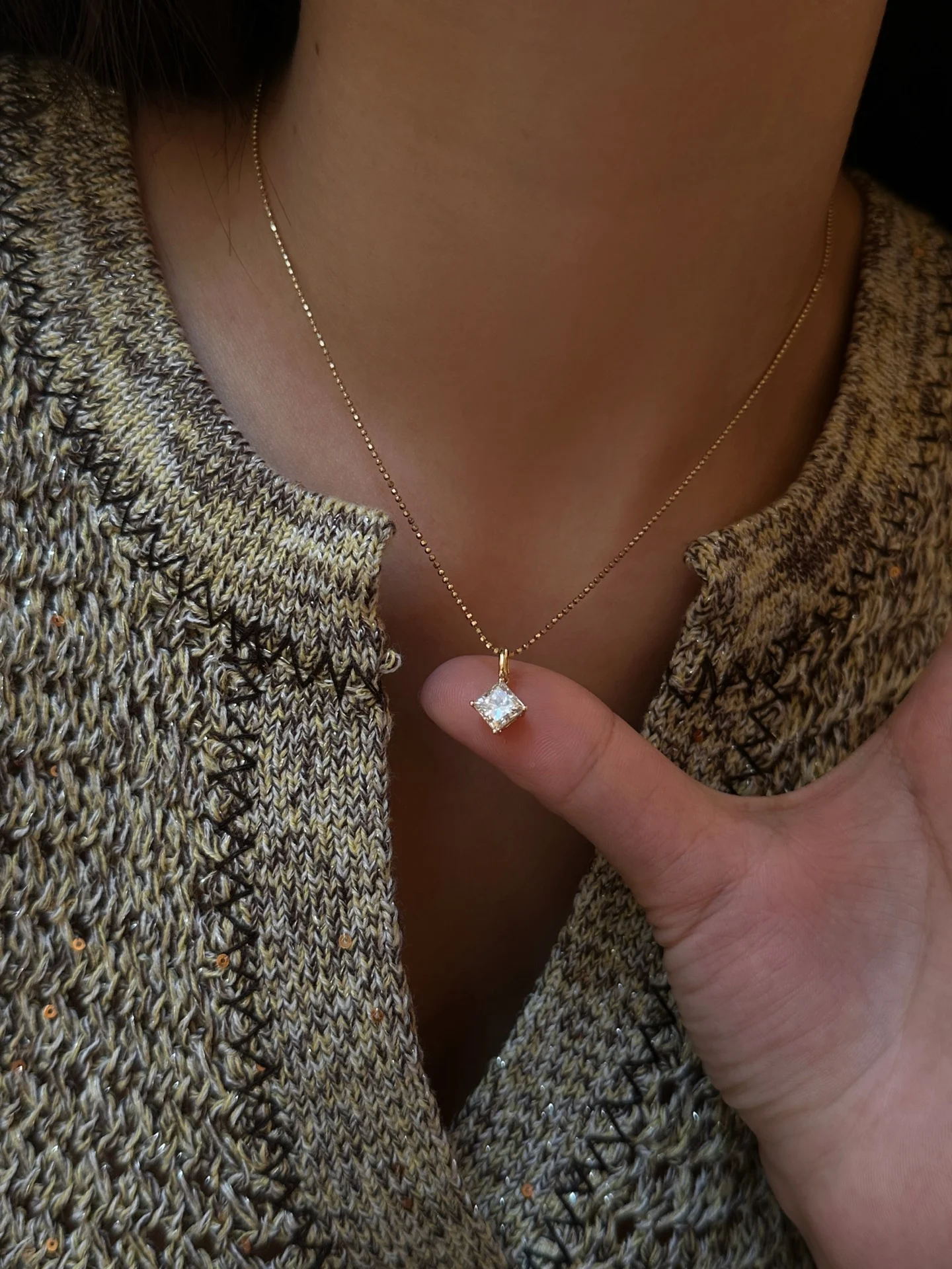 Square pendant 002 · Hand-held scale while worn (supplied photograph)